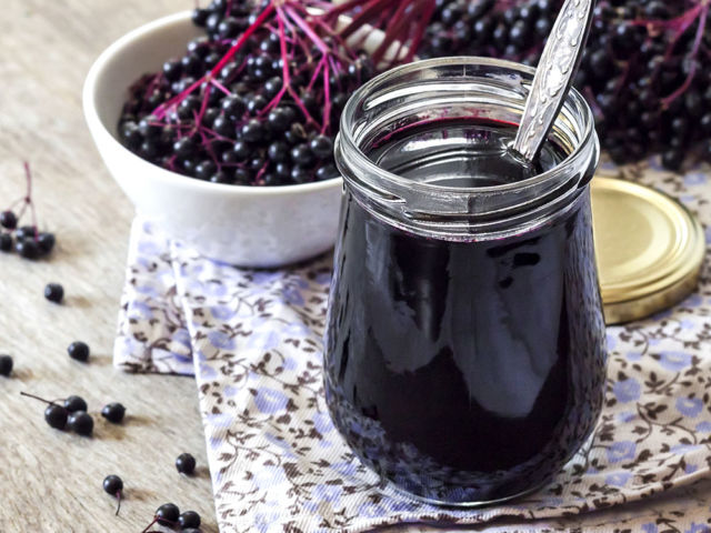Homemade black elderberry syrup in glass jar